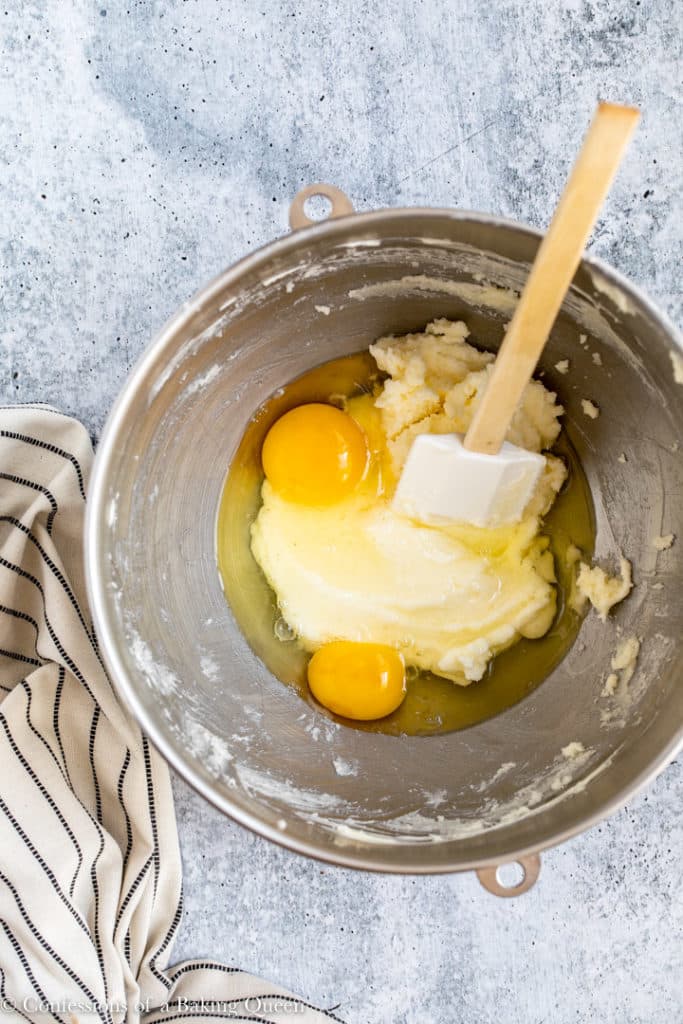 eggs added to butter mixture in a metal mixing bowl