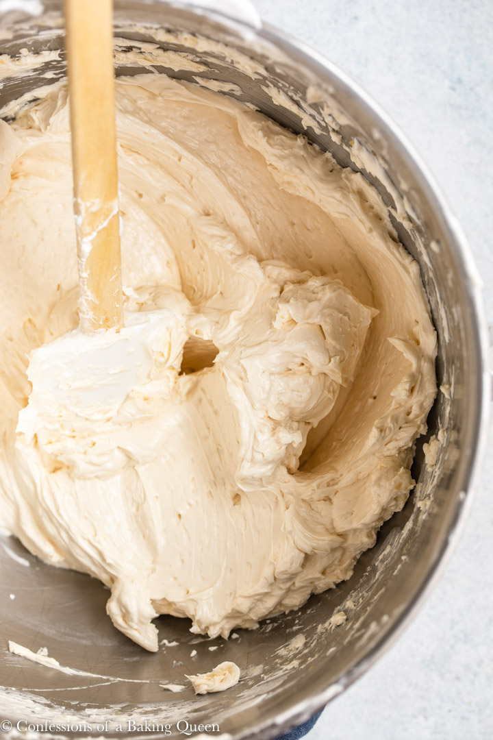 baileys Swiss meringue buttercream ready to pipe in a metal mixing bowl on a light grey surface