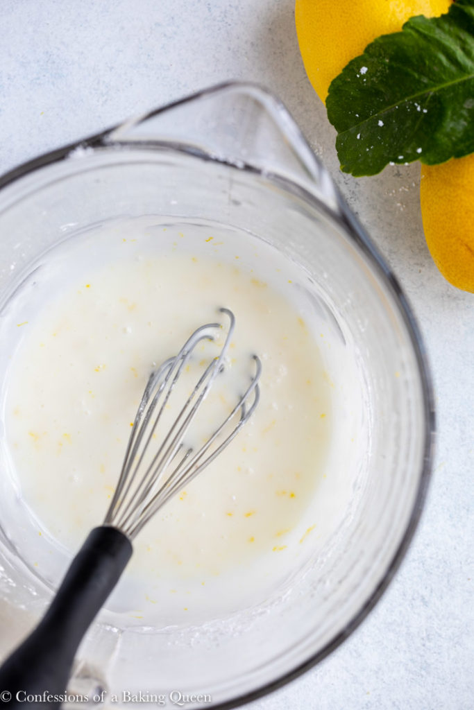 lemon glaze in a glass bowl with a whisk