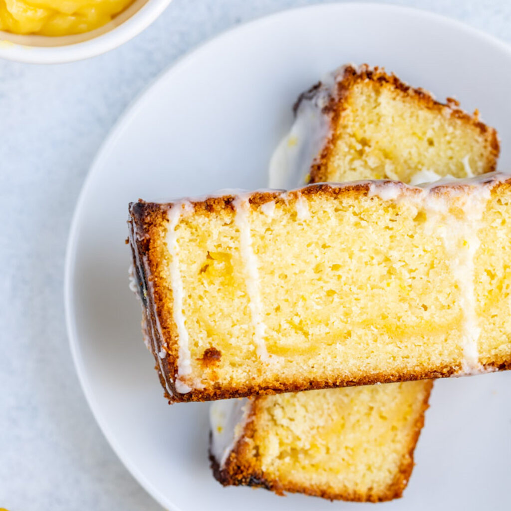 lemon curd lemon loaf cake stacked on top of each other on a white plate