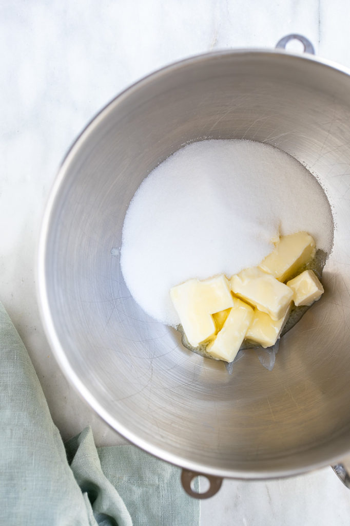 granulated sugar and butter in a metal mixing bowl