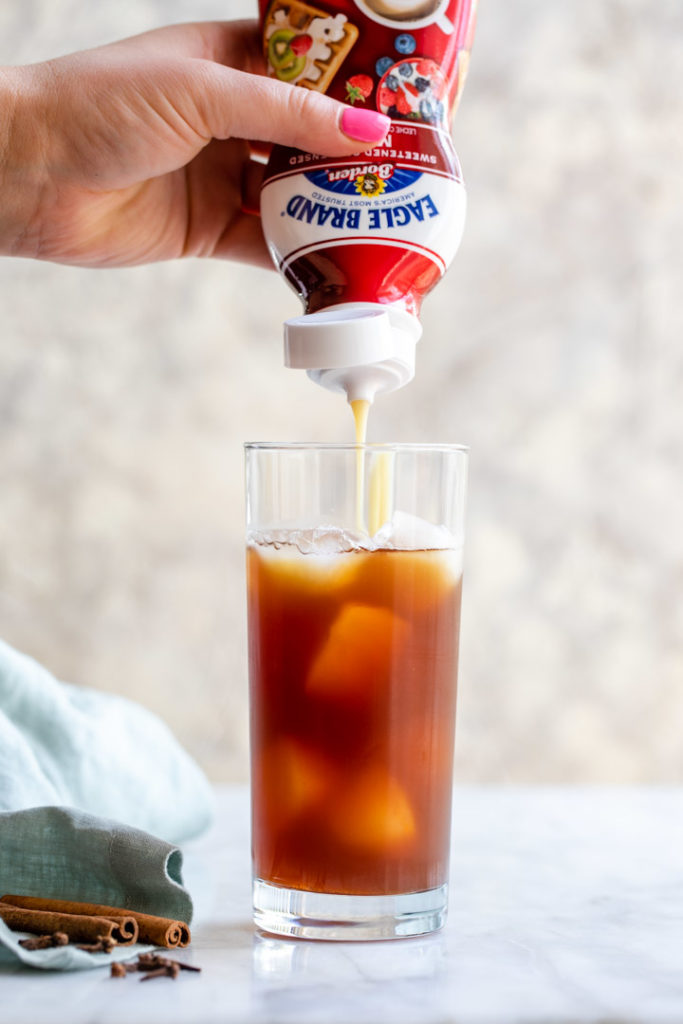 eagle brand sweetened condensed milk squeezed into thai iced tea
