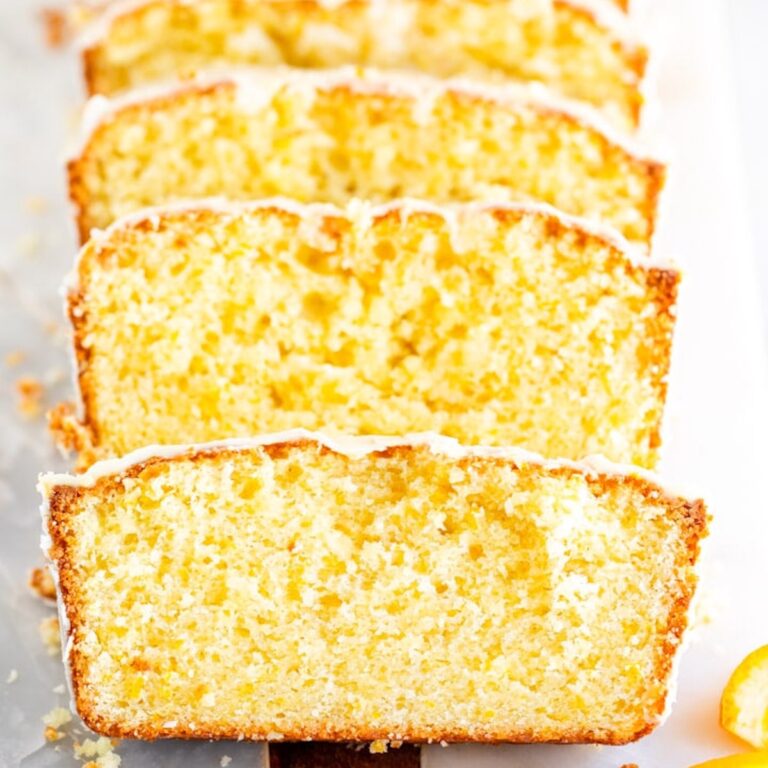 close up of orange loaf cake recipe on a white surface