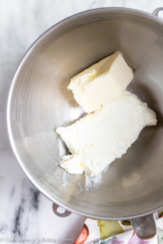 cream cheese and butter in a metal mixing bowl