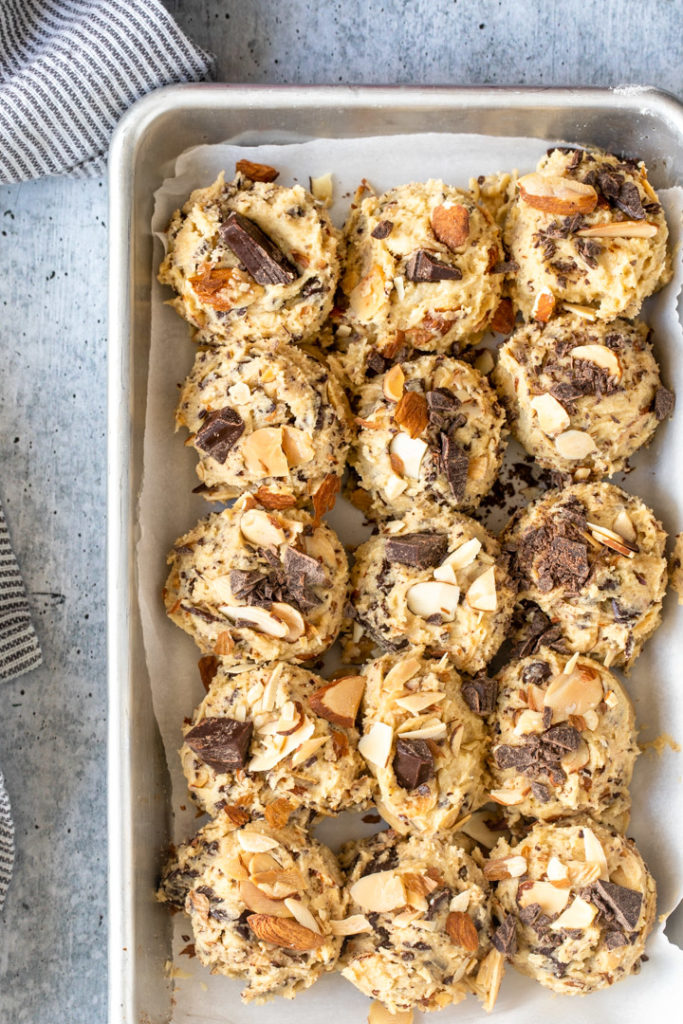 almond chocolate chip cookie dough balls on a baking sheet