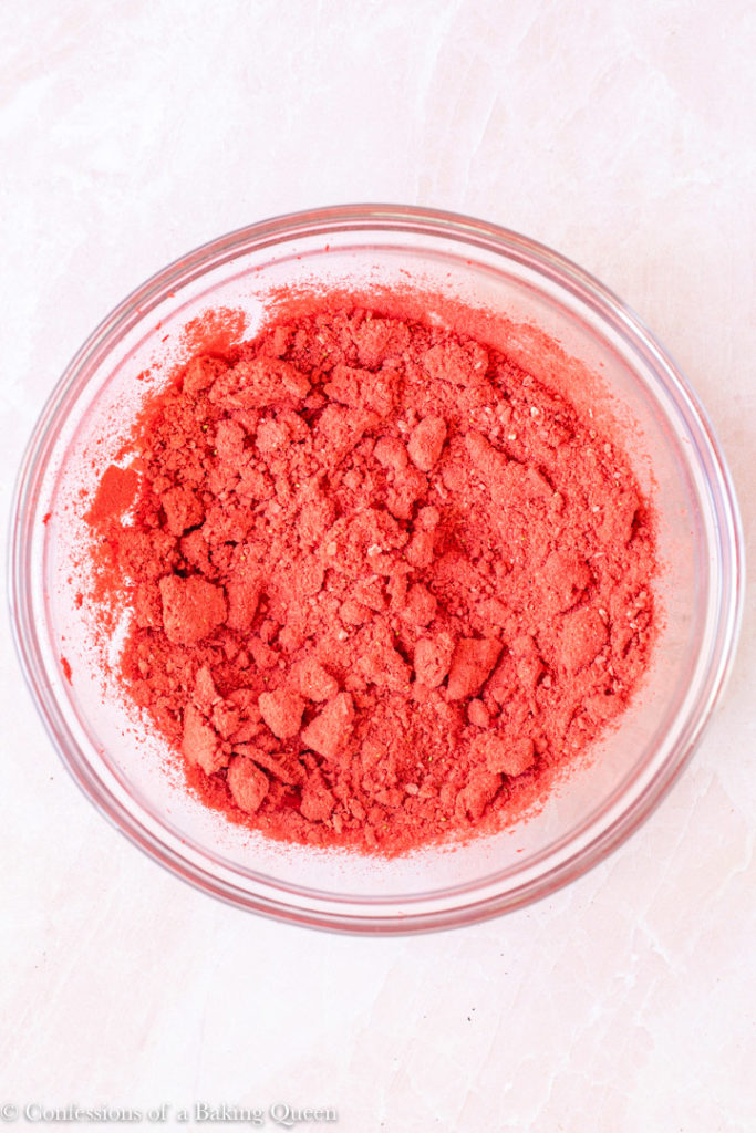 freeze dried strawberry powder on a light pink background