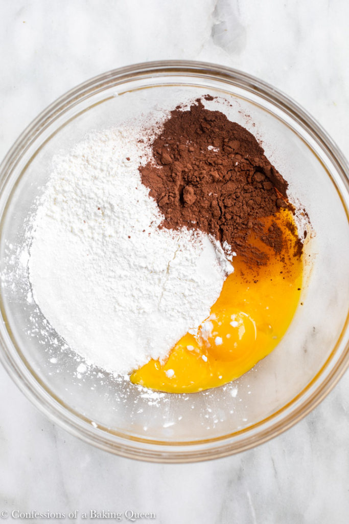 egg yolks, sugar, cornstarch and cocoa powder in a large glass bowl for a chocolate pastry cream recipe