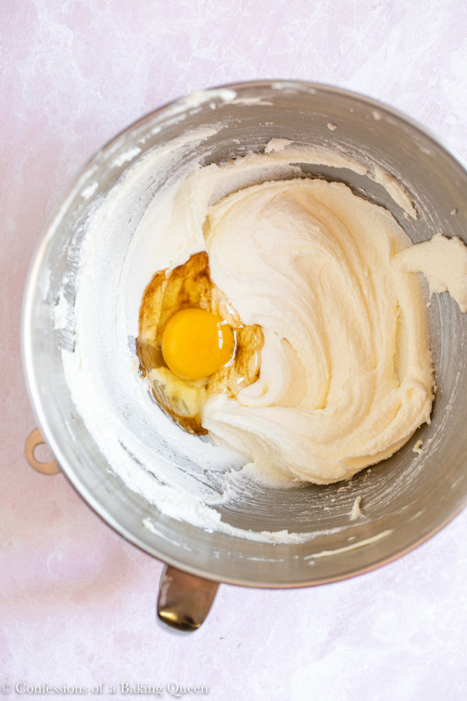 egg added to sugar and butter mixture in a large metal bowl