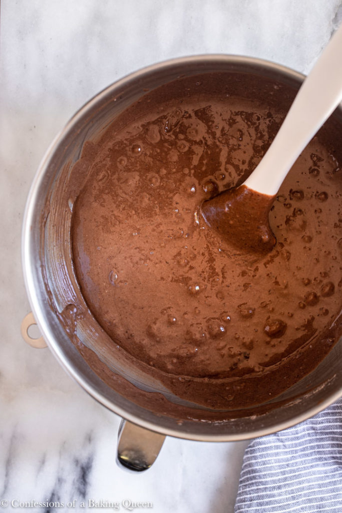 chocolate cake batter in a metal mixing bowl