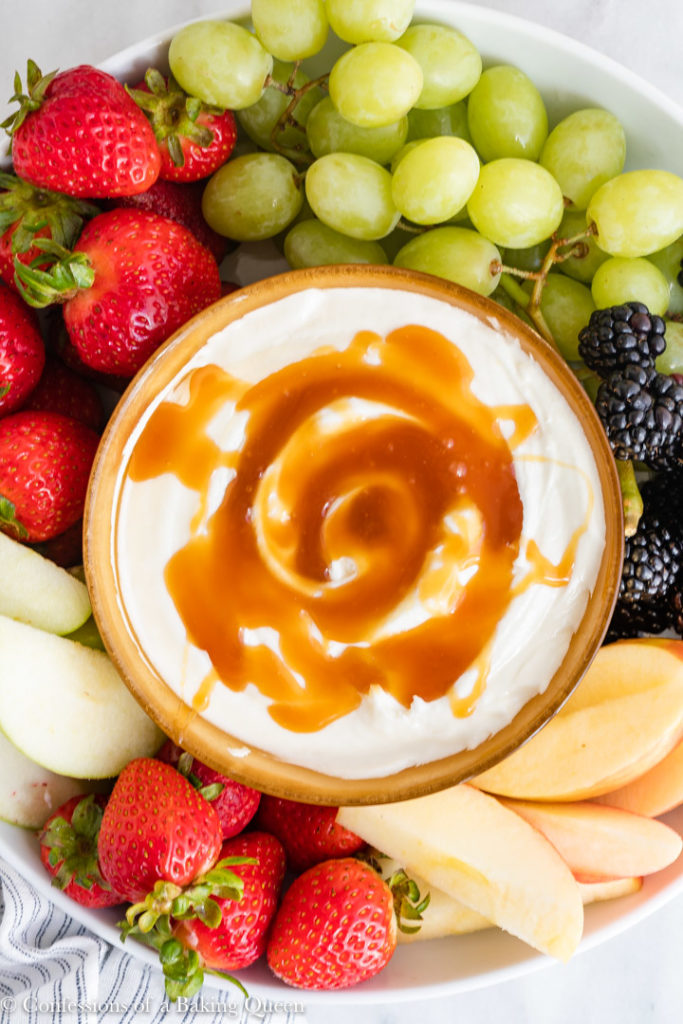 sweet cream cheese dip surrounded by fruit in a platter