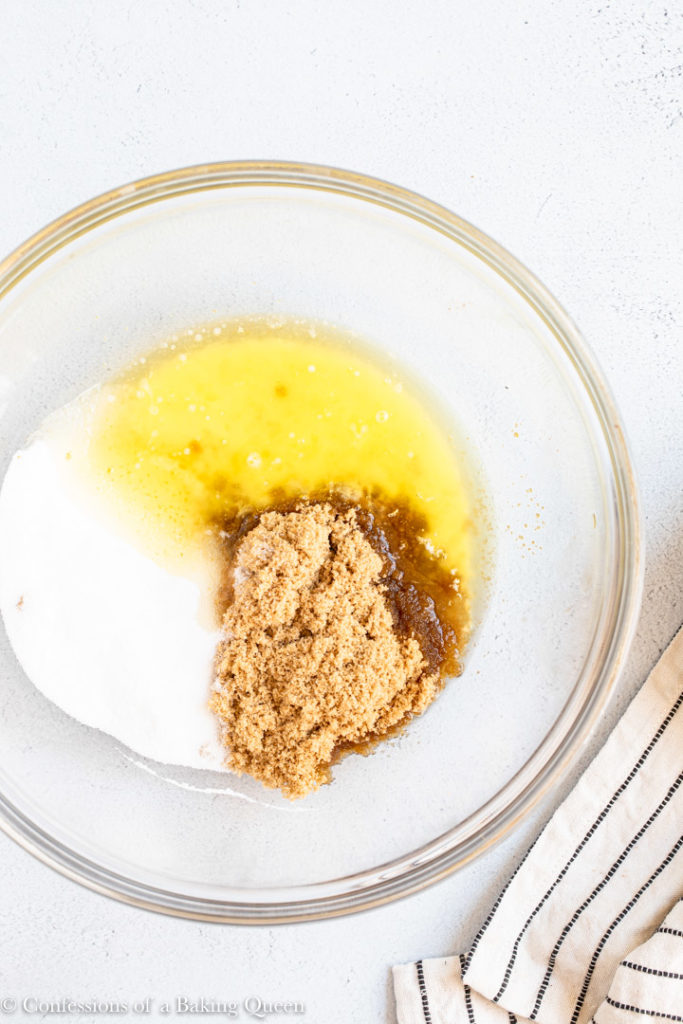 melted butter, granulated sugar and brown sugar in a large glass bowl