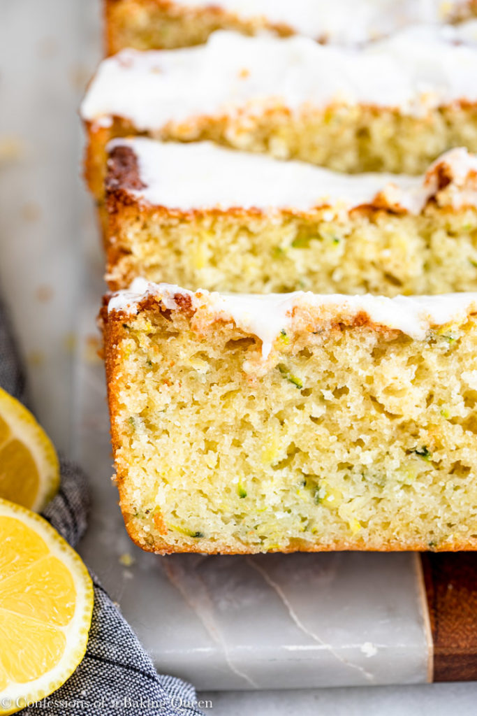 slices of lemon zucchini cake on a marble board