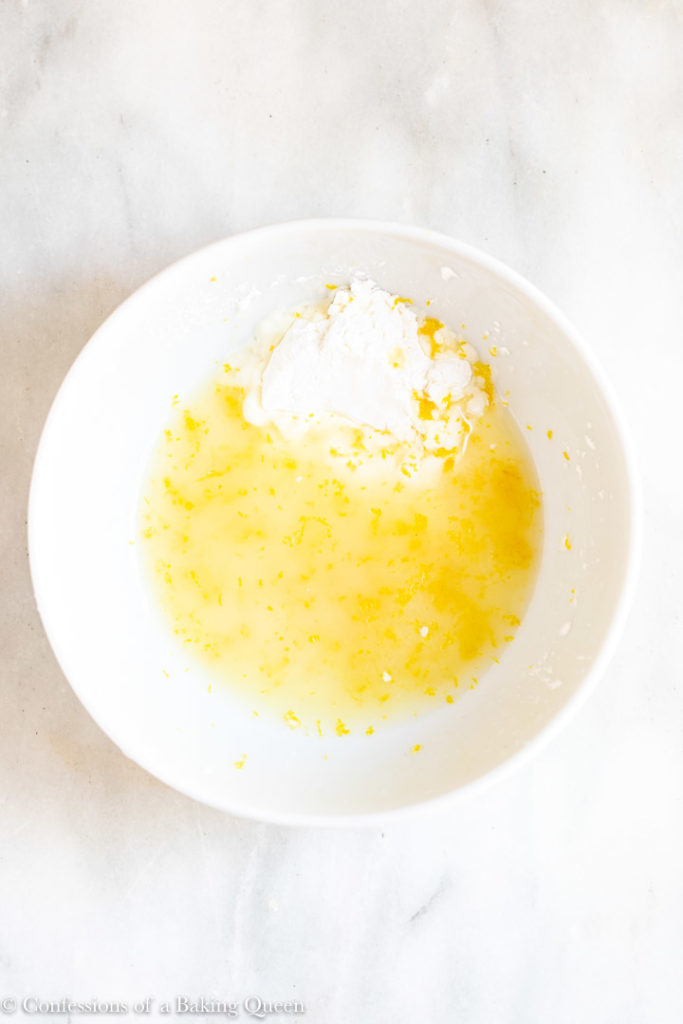 lemon juice and cornstarch in a white bowl on a marble surface