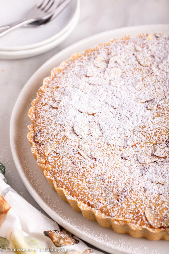 powdered sugar dusted on top of a bakewell tart