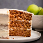 apple spice cake cut open on a white plate