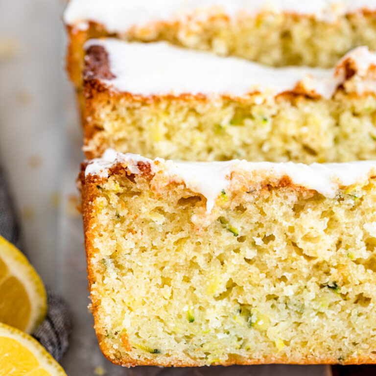 slices of lemon zucchini cake on a marble board