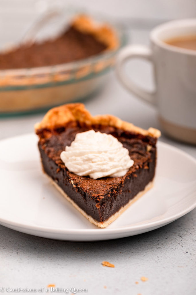 piece of chocolate chess pie with a dollop of whipped cream 