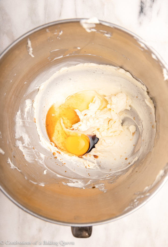 egg, vanilla extract, almond extract added to butter and sugar in a large metal bowl