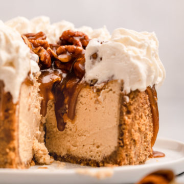 cut open pecan pie cheesecake on a white plate