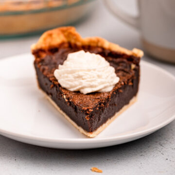 piece of chocolate chess pie with a dollop of whipped cream