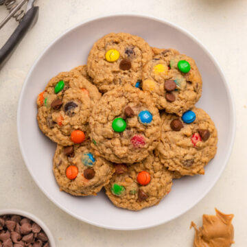 cropped-plate-full-of-monster-cookies-next-to-a-cup-of-chocolate-chip-oats-and-mms-and-a-spoon-full-of-peanut-butter-1-of-1.jpg