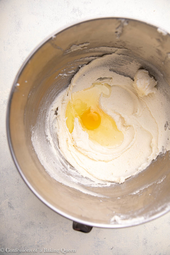 egg added to creamed butter and sugar in a large metal bowl 