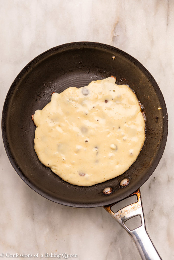 pancake cooking and bubbling in frying pan (