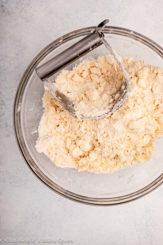 butter rubbed into flour with a pastry blender in a glass bowl