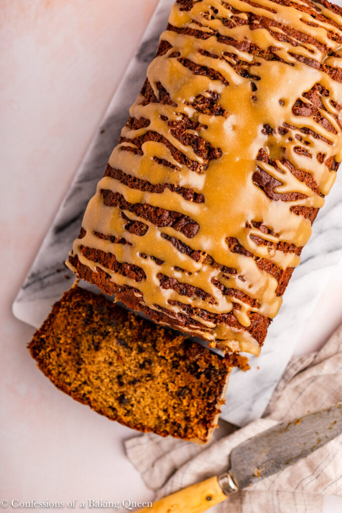 sticky toffee loaf cake cut open on a marble slab