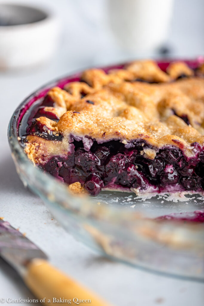head on view of cut open blueberry pie in a glass dish