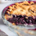 head on view of cut open blueberry pie in a glass dish