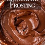 up close of chocolate frosting recipe in a glass bowl on a light grey surface