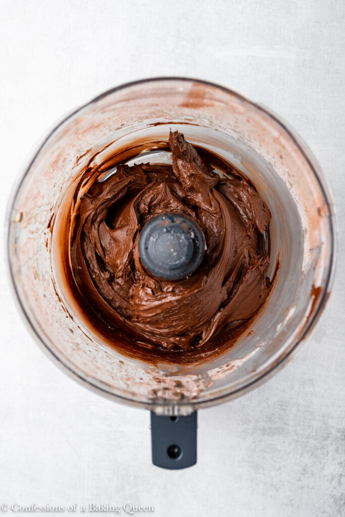 chocolate frosting scraped down in the bowl of a food processor