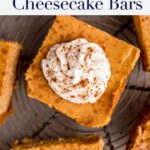up close of pumpkin cheesecake bars on a wire rack on a brown surface
