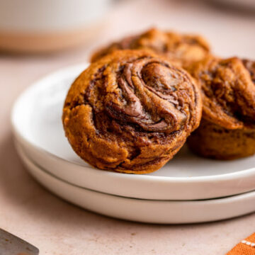 cropped-nutella-pumpkin-muffins-on-white-plates-on-a-light-brown-surface-with-a-wooden-knife-and-orange-linen-1-of-1.jpg