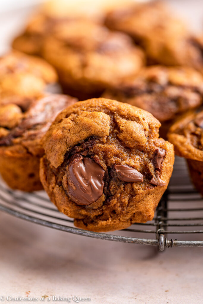 up close of nutella pumpkin muffin on a wire rack on a light brown surface