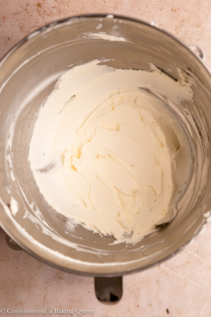 whipped cream cheese and butter in a metal bowl on a light brown surface