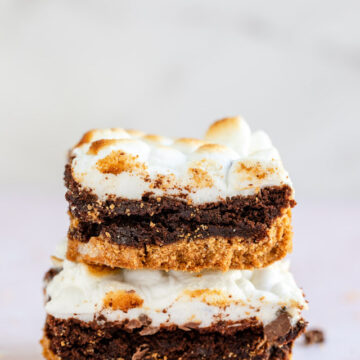 stack of smores brownies on a light pink surface