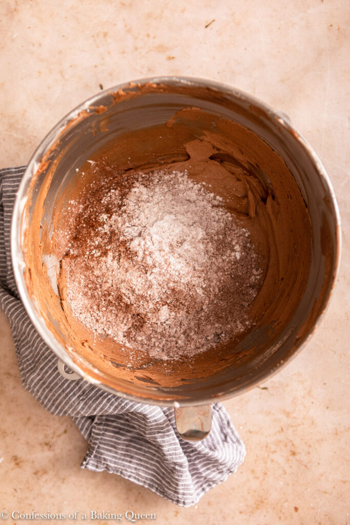 remaining confectioners sugar and cocoa mixed into butter on a light brown surface with a blue linen