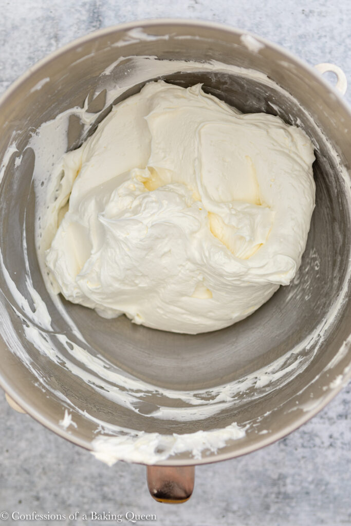 close up of freshly whipped Swiss meringue buttercream on a light grey surface