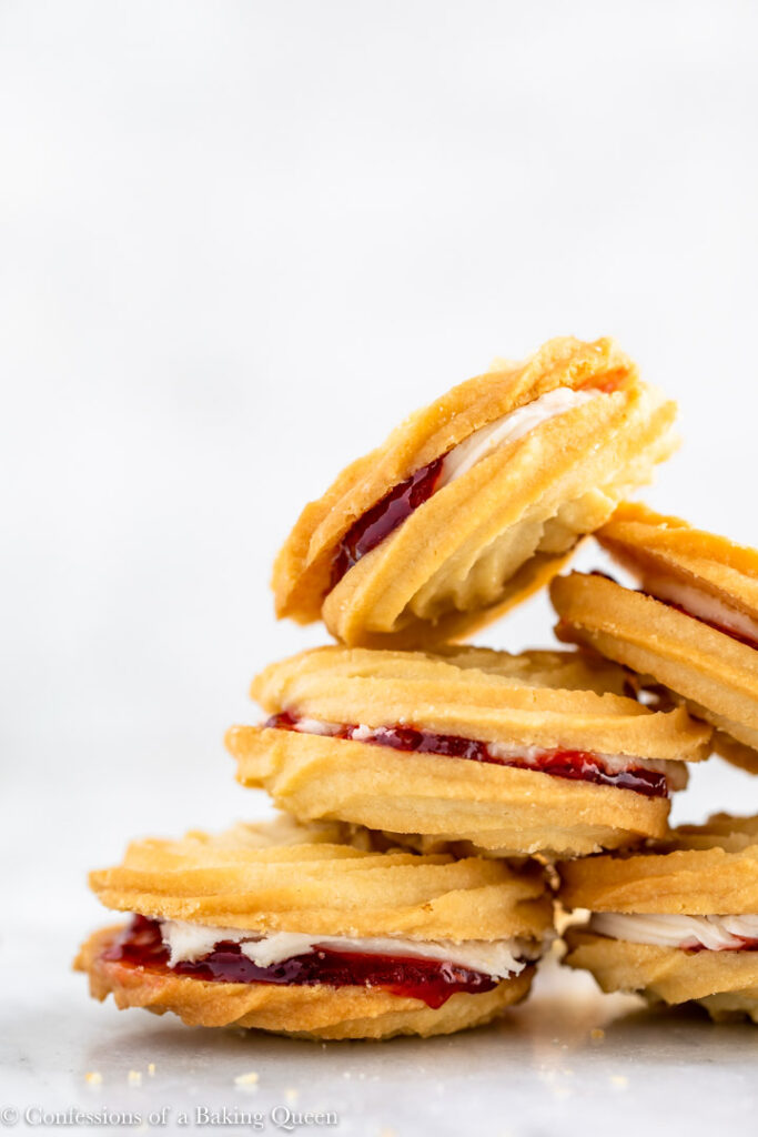 Viennese whirl biscuits with jam on a white background