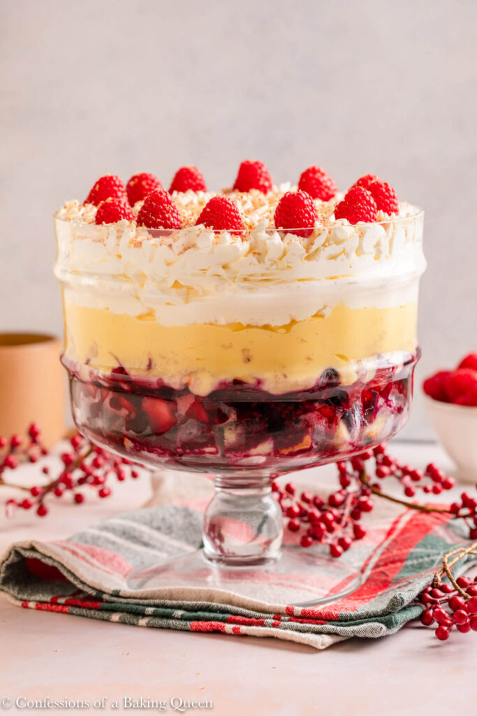 christmas trifle on christmas linen with chirmstas berries on a light pink surface