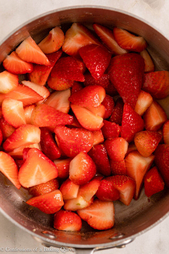 strawberry compote cooking in a metal pot