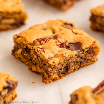 pecan chocolate chip blondies on a white marble surface