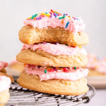 stack of sugar cookies on a metal rack on a light surface