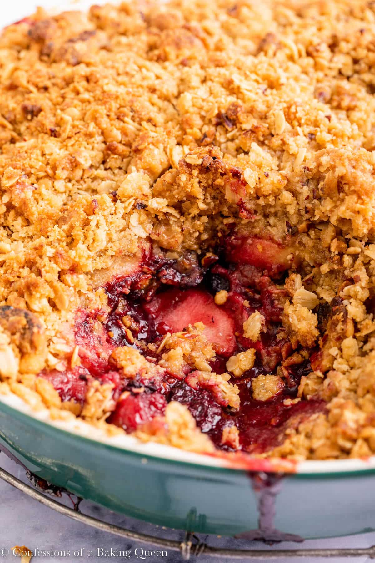 close up of apple and blackberry crumble with a scoop missing