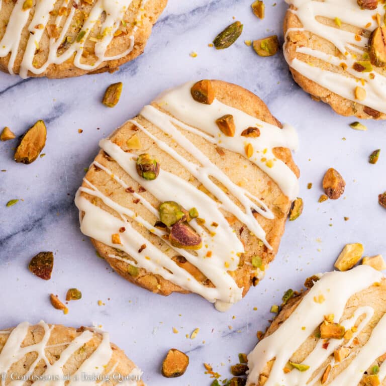 white chocolate pistachio shortbread cookies on a marble surface