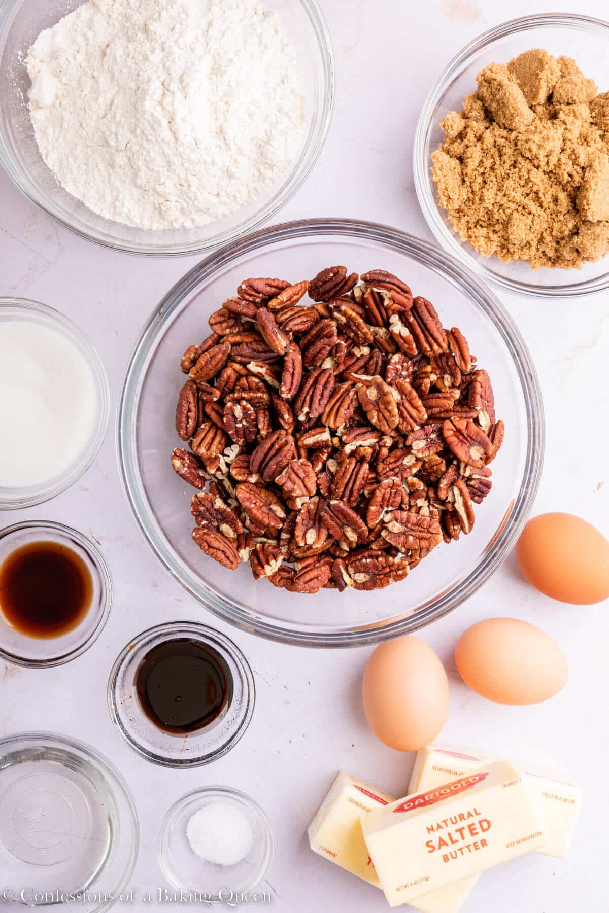 ingredients for pecan pie bars laid out on a light pink surface