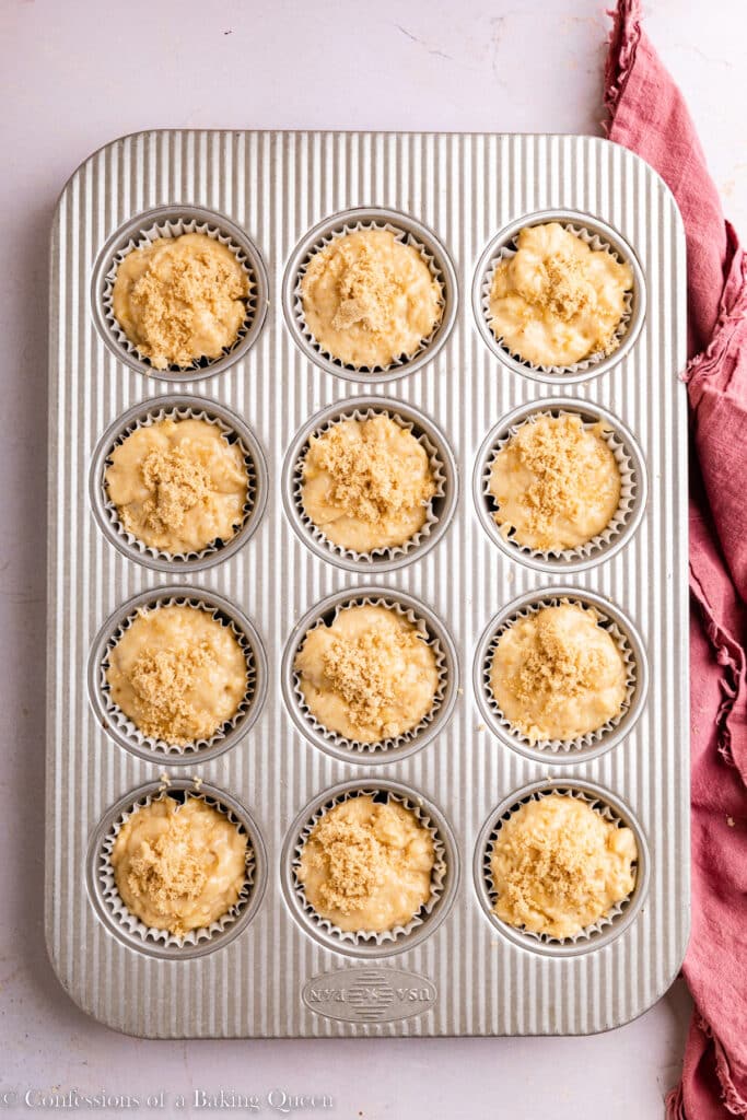 Muffin batter in muffin tins before baking.