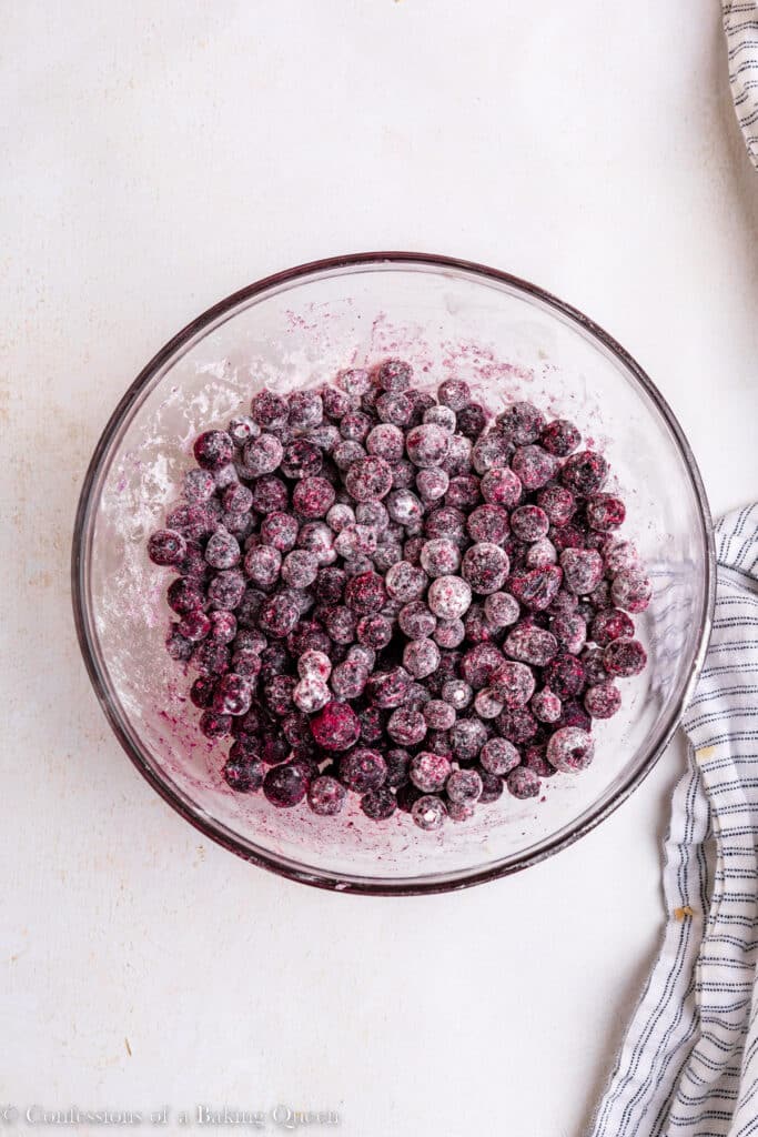 Blueberries coated in flour in a mixing bowl.